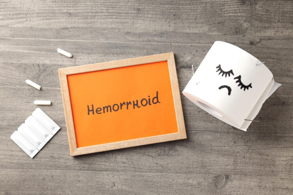 Czopki, papier toaletowy i tabliczka z napisem hemoroidy
